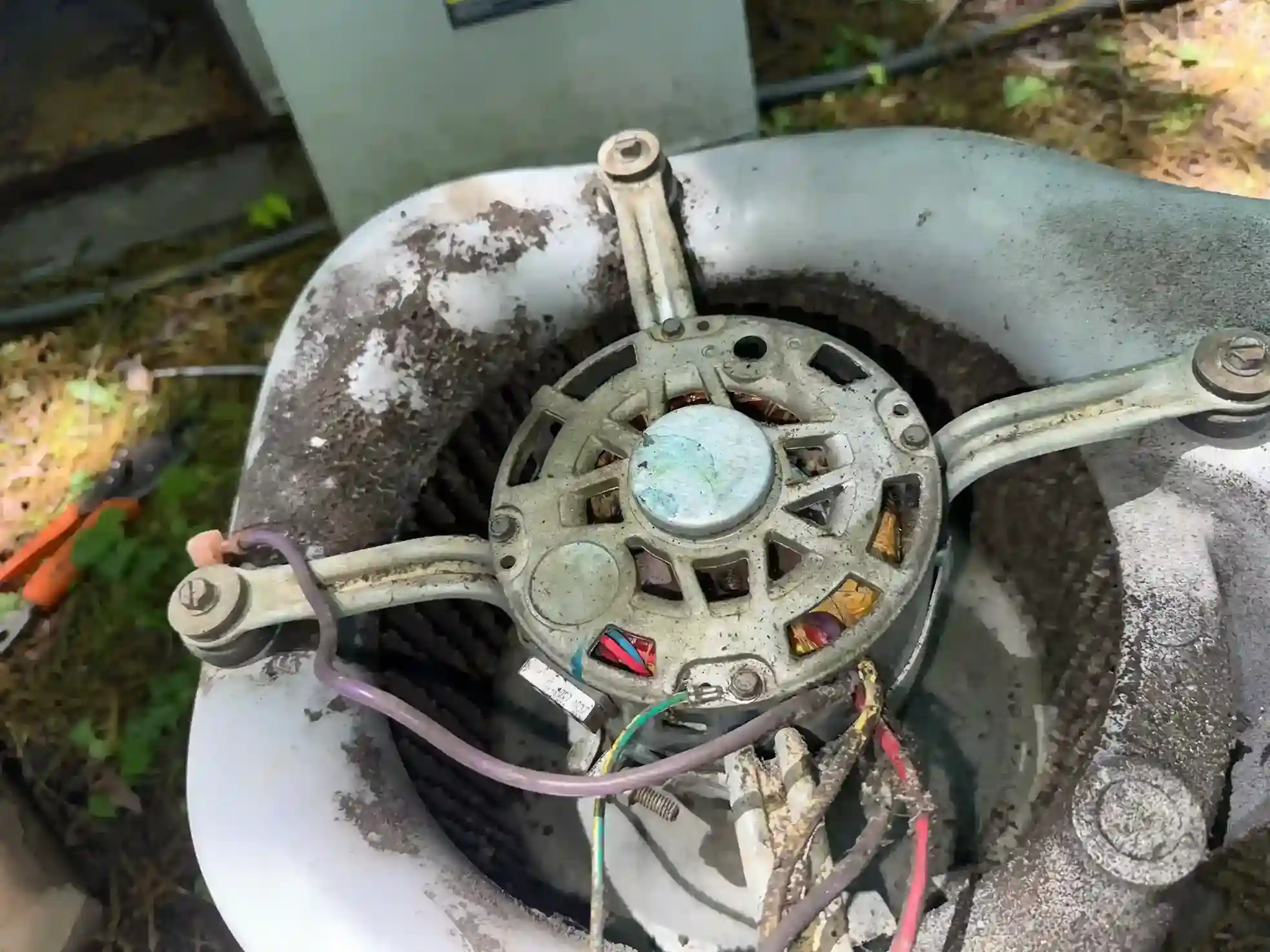 Heavily soiled AC blower motor assembly extracted from air handler unit