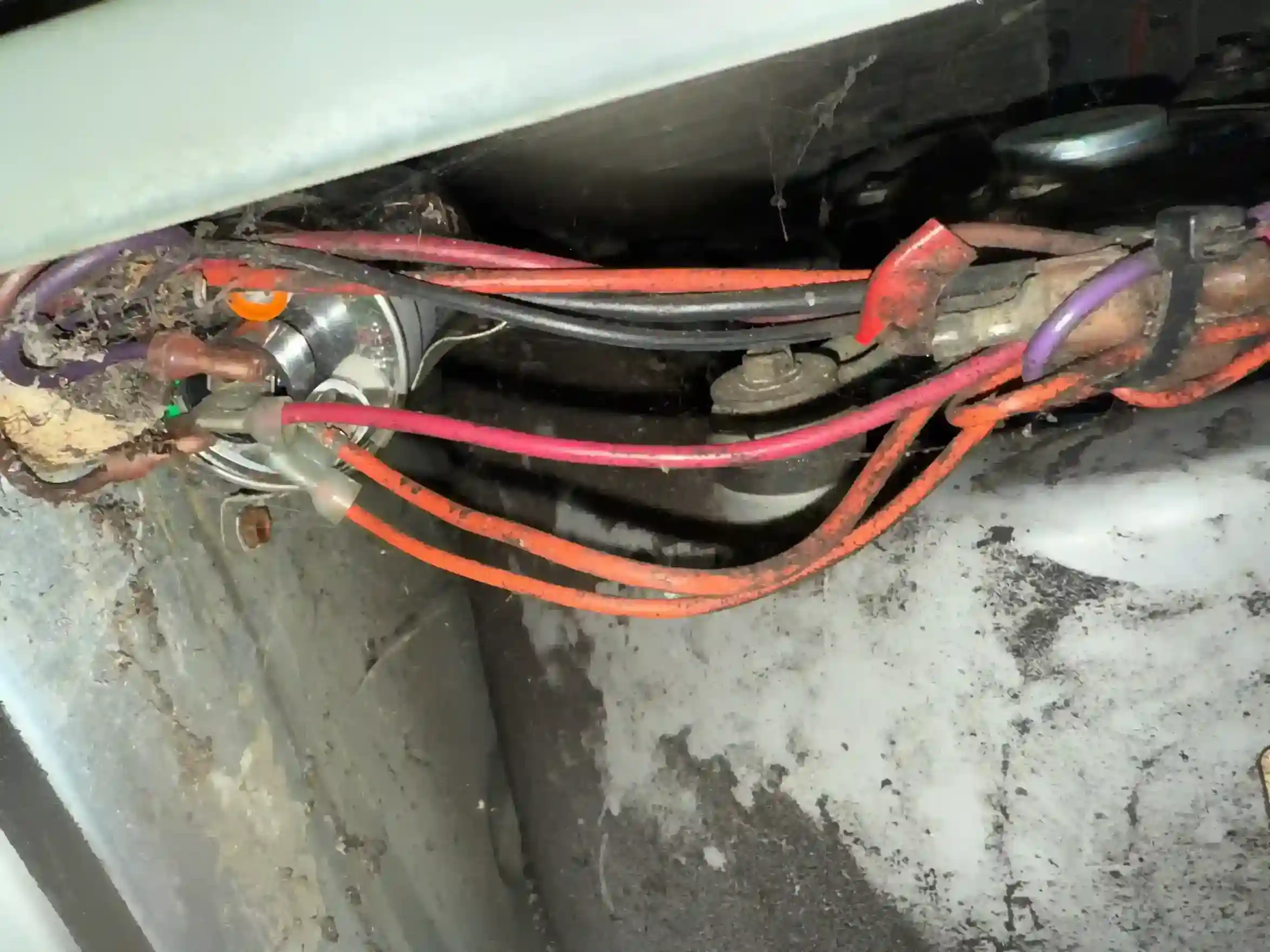 Loose and disorganized control wires alongside blower motor components inside air handler