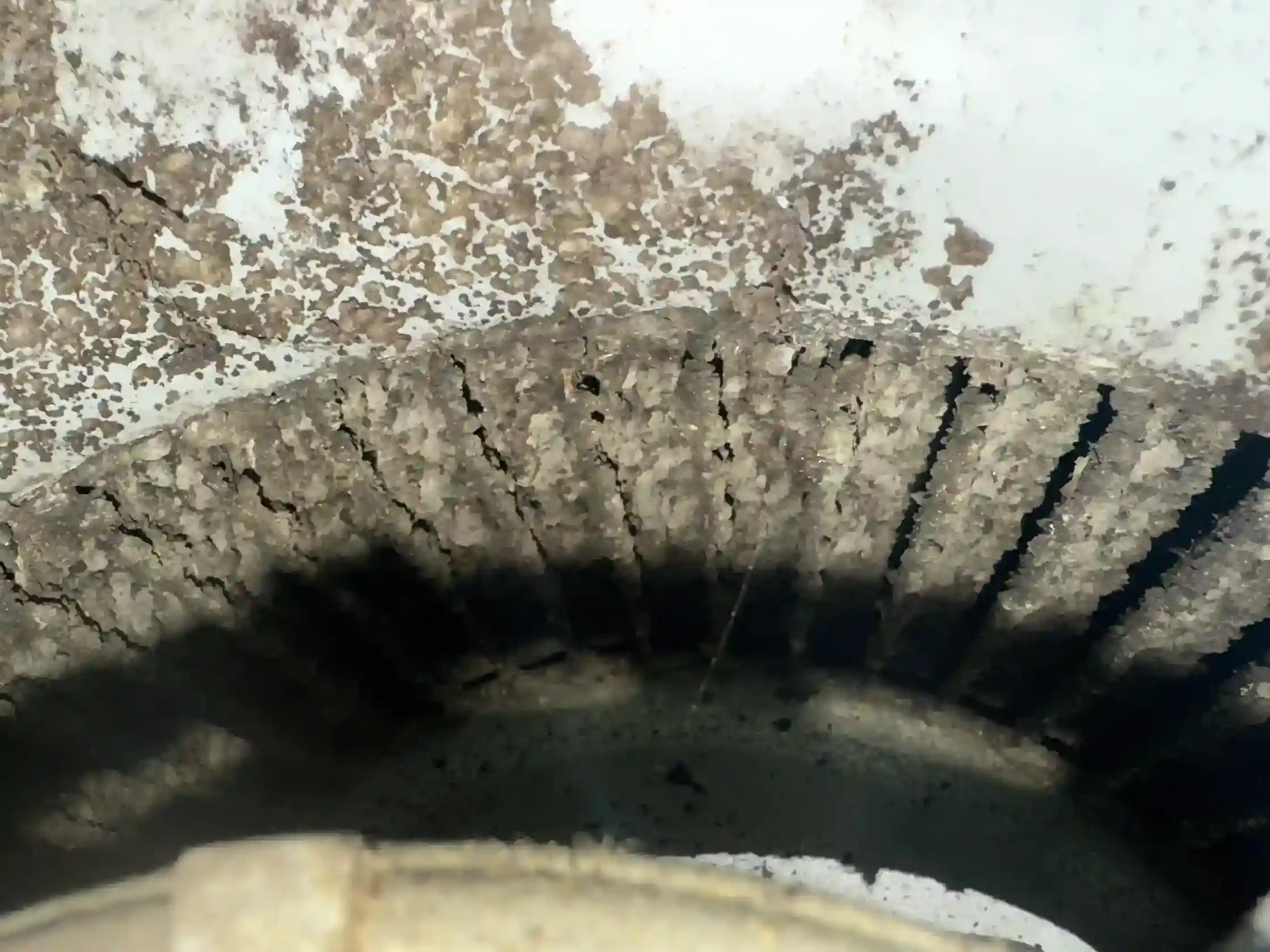 Squirrel cage blower wheel fins severely caked with dust and debris