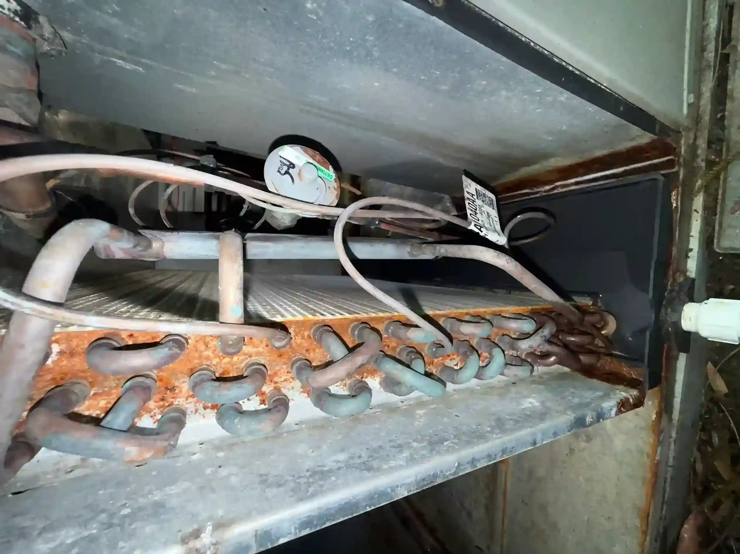 Severe corrosion on evaporator coil return bends and drain pan inside air handler