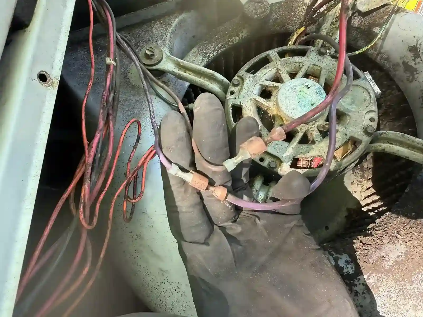 Technician Toy performing hands-on inspection of HVAC component during final quality check
